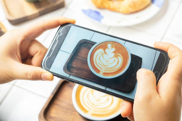 istock take photo latte coffee with mobile phone 1159590103