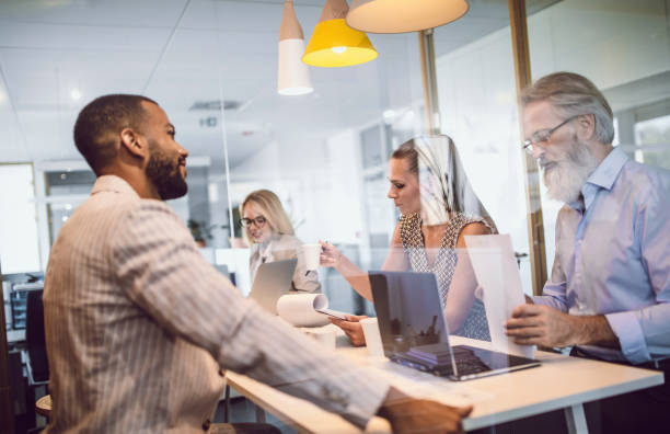 istock Business People Sitting in The Office, Discussing 1159590469