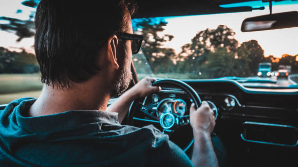 istock Driver in  a vintage car. Golden hour 1159591349