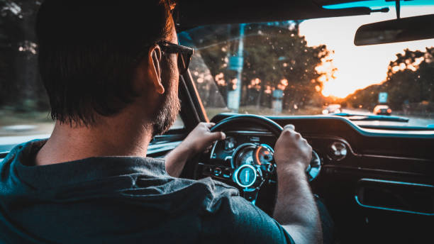 istock Driver in  a vintage car. Golden hour 1159591356