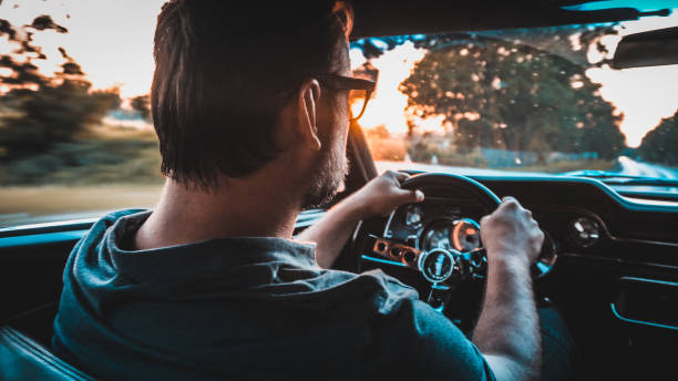 istock Driver in  a vintage car. Golden hour 1159591364