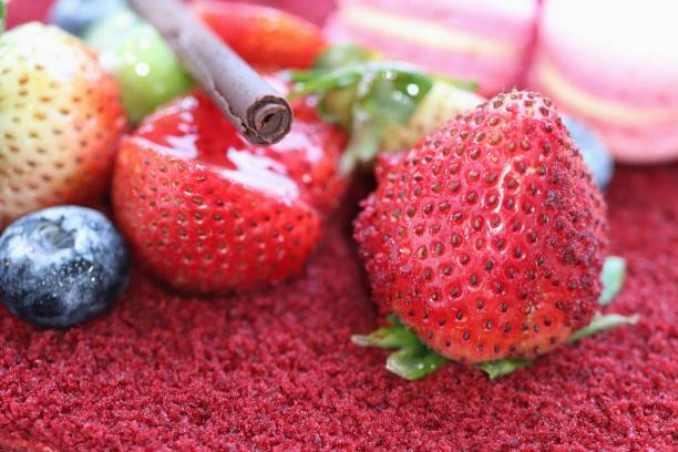 istock close-up fresh strawberry on top red valet cake 1159591459