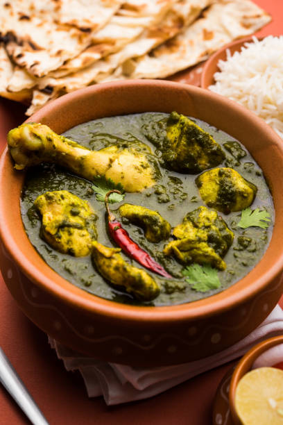 istock palak/spinach Chicken or Murg Saagwala served in a bowl with Naan and rice 1159591683
