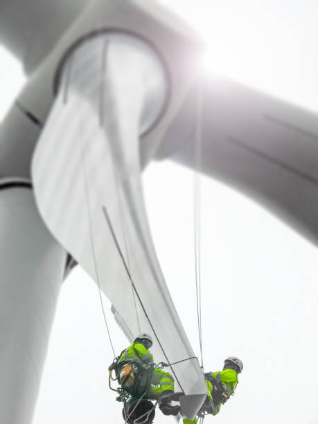 istock Rope access technician doing blade inspection on the tip on wind turbine 1159594801