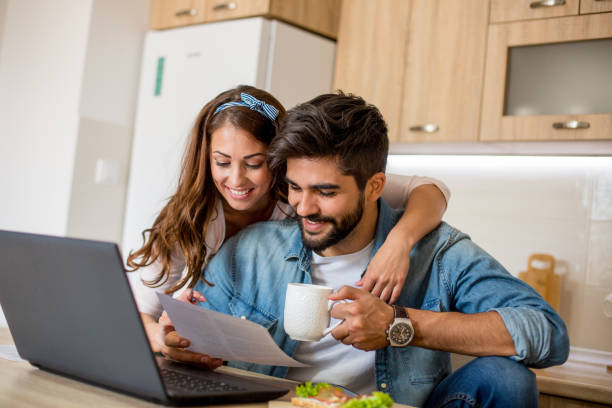 istock Couple paying bills online at home 1159595027