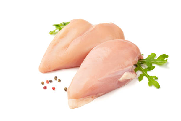 istock Raw chicken meat with spices, isolated on white 1159596684