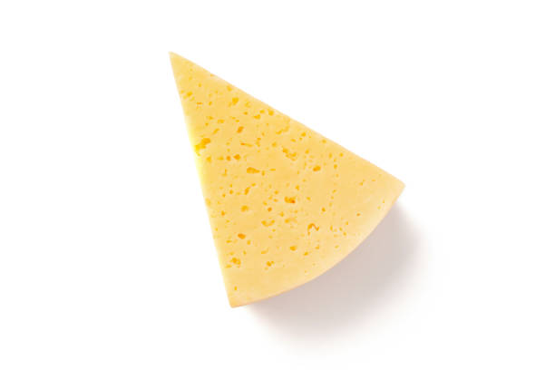 Slice of gouda on a white background Big triangle piece of yellow gouda cheese on white background cheddar cheese stock pictures, royalty-free photos & images