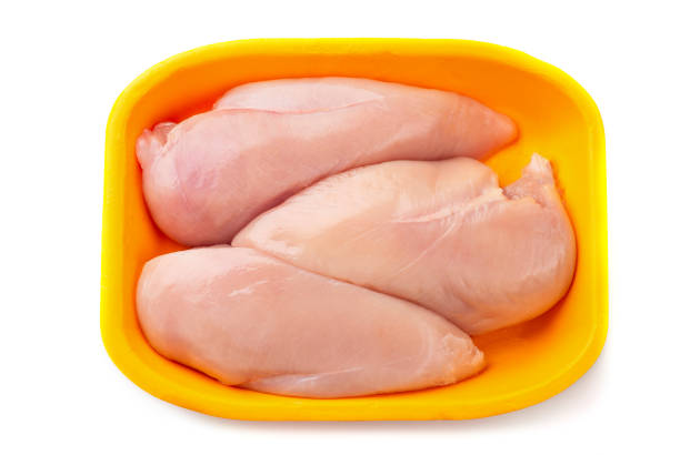 istock Raw chicken fillet package isolated on white background. 1159596807