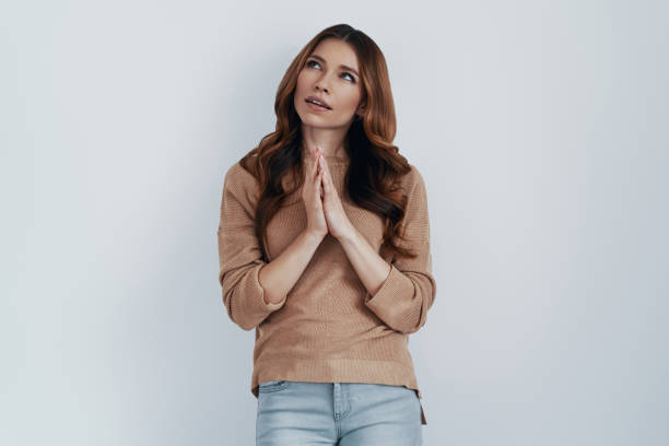 istock Free your imagination! Beautiful young woman looking away while standing against grey background 1159598094