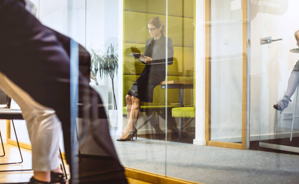 istock Businesswoman Standing in The Corridor, Using Digital Tablet 1159598410