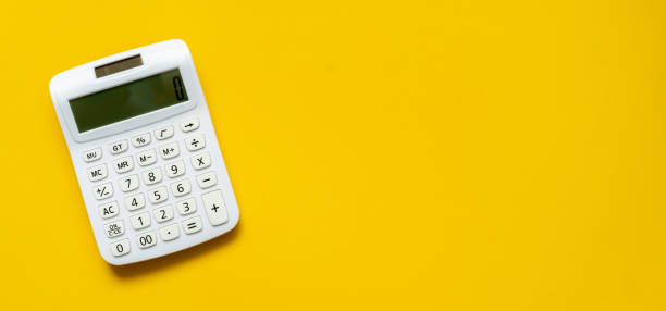 close up top view white calculator on yellow background with copyspace for counting and planning about monthly expenses at home for retirement lifestyle concept close up top view white calculator on yellow background with copyspace for counting and planning about monthly expenses at home for retirement lifestyle concept counting photos stock pictures, royalty-free photos & images