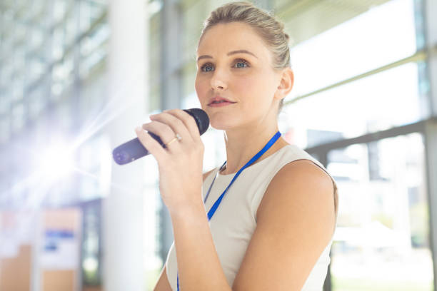 istock Young Caucasian businesswoman doing a speech in conference room 1159601921