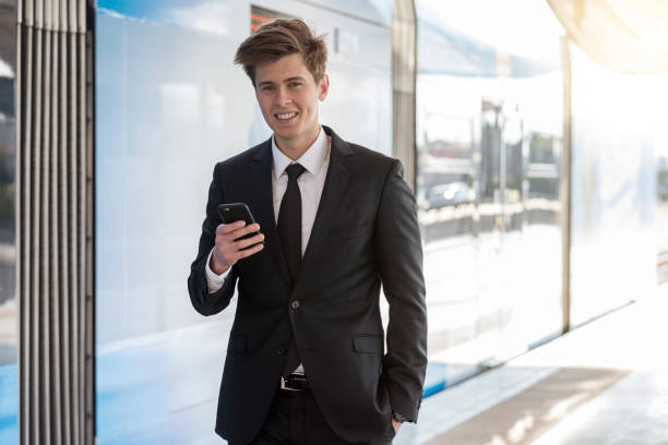 istock Businessman using mobile phone in train station 1159603391