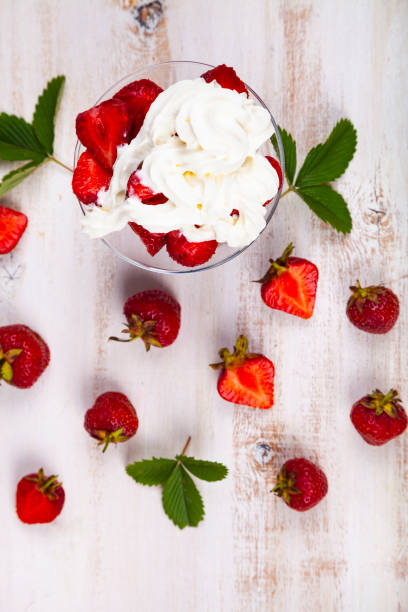 istock Strawberries and cream in a transparent bowl 1159604602