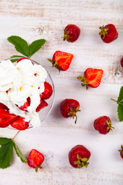 istock Strawberries and cream in a transparent bowl 1159604743