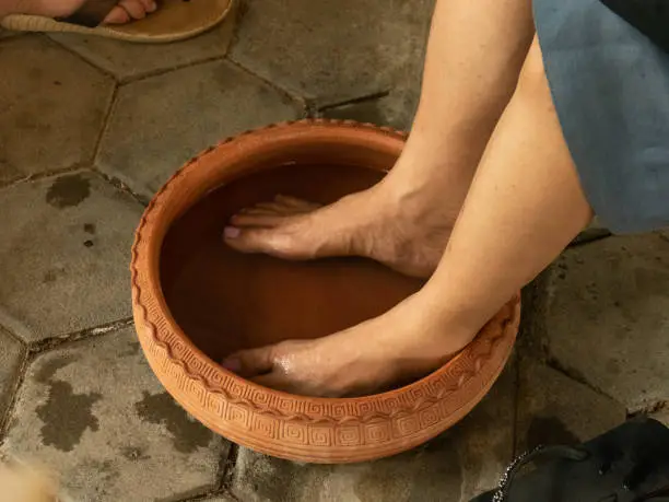 Soaking feet into warm water before thai foot massage