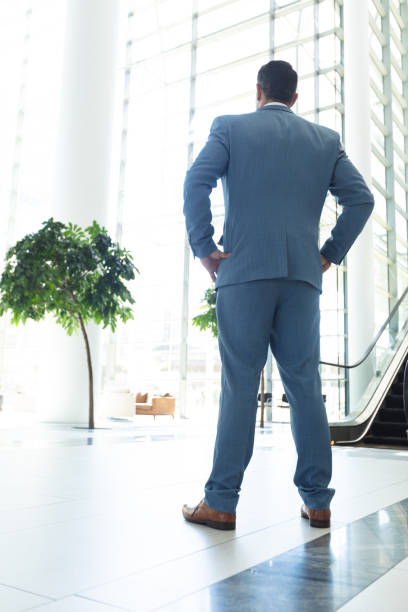 istock Thoughtful mature Caucasian businessman standing in modern office 1159605773