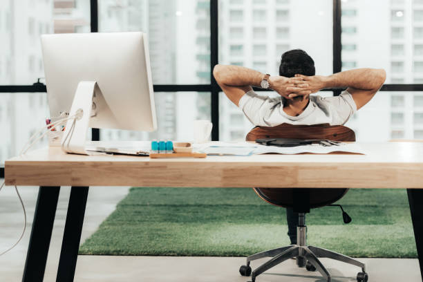 istock Relax time.  Successful Businessman relaxing  and resting after sitting and hard working in modern office. Healthy care for time. Business Concept 1159605799