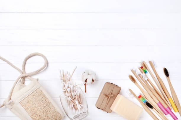 istock Bamboo toothbrushes with soap, washcloth and cotton sticks on white wooden table 1159605949