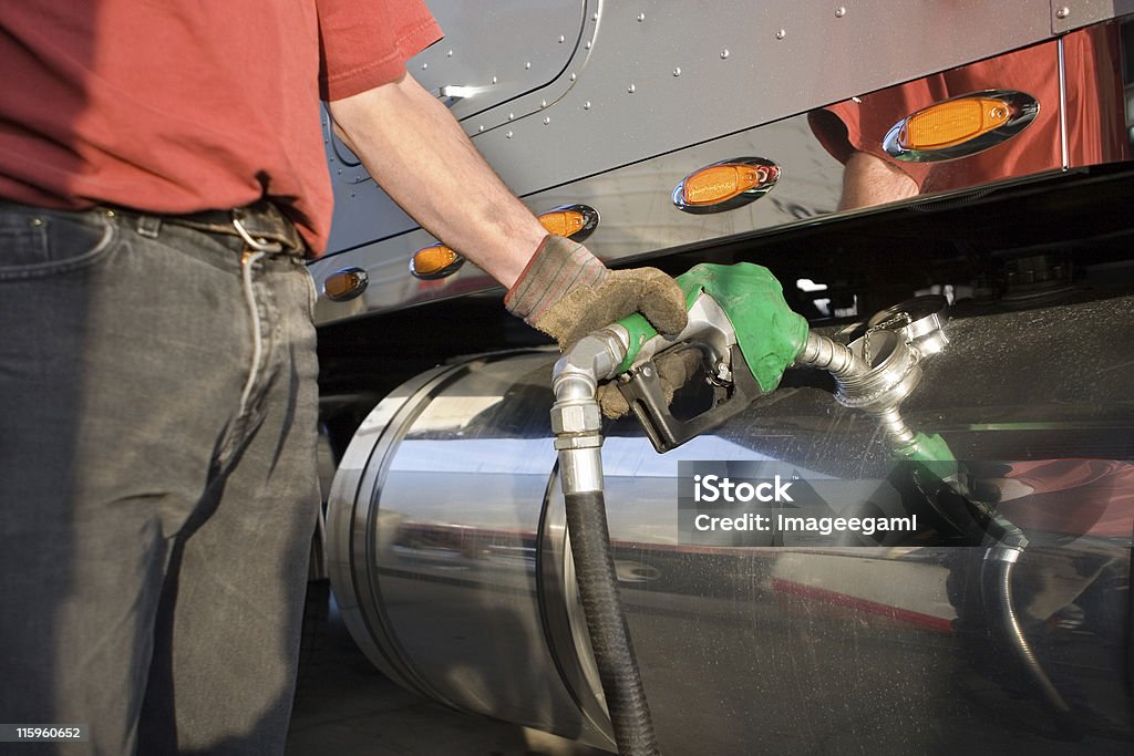 A man fueling a gas tank of a truck Diesel Fuel Pump, Semi Truck Diesel Fuel Stock Photo