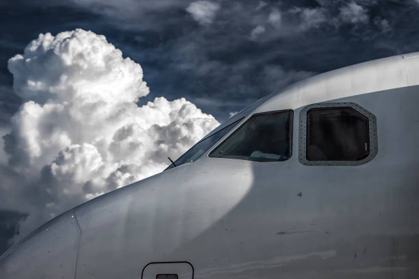 Nose of the plane and white clouds