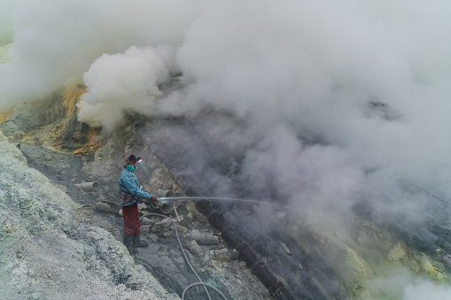 hot mineralized lake with thermal spring and smoking fumaroles in the caldera of the Golovnin volcano on the island of Kunashir