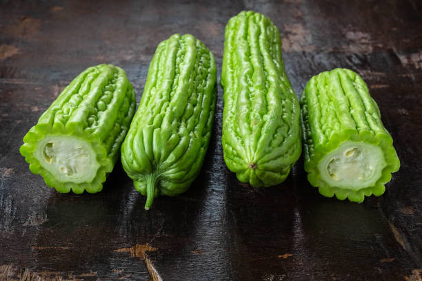 istock Fresh bitter gourd on a wooden background 1159609714