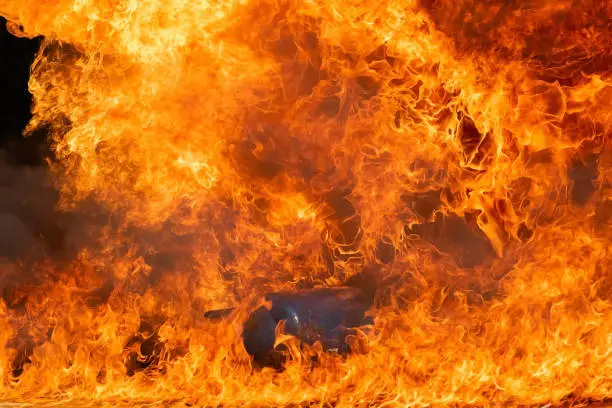 Photo of Burning fire flame with fuel oil, Gasoline burning up in container, Fire smoke and pollution