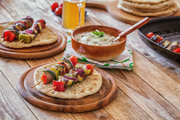 Greek cuisine, souvlaki, grilled pork chops served with flatbread and tzatziki salad, close up, no people
