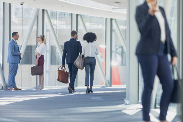 istock Diverse business people walking in corridor in modern office 1159613787