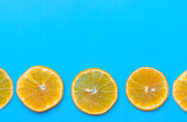 istock Summer of slice orange fruit on blue background. 1159614109