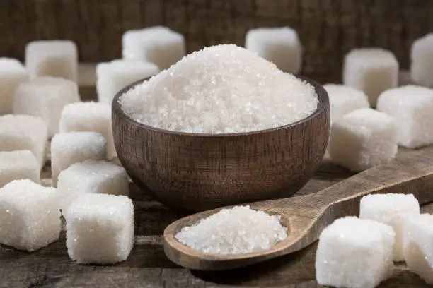 Photo of White refined sugar powder and cubes