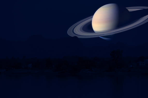 istock Saturn on night sky back silhouette mountain and river 1159615543