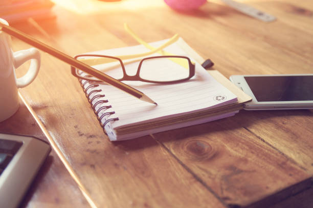 istock Notebook, laptop,glasses and cup of coffee with cactus on wood table with copy space 1159615818