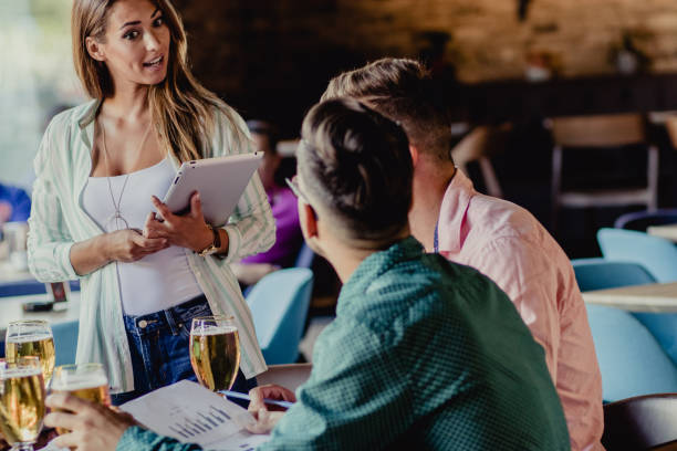 istock Casual business meeting in bar. Young coworkers. 1159616632