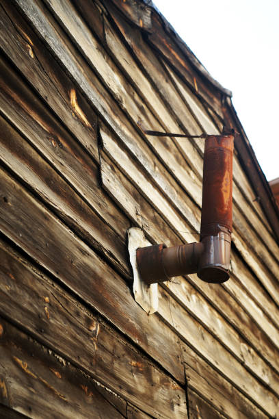 istock tin chimney on old wooden wall 1159617138