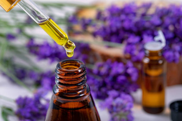 istock lavender essential oil drop from pipette over the bottle 1159618398