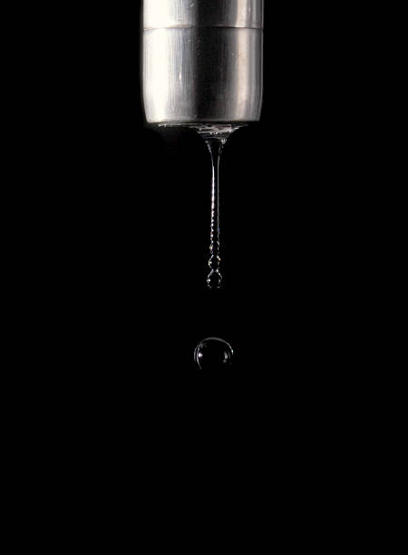 Faucet Drip on Black Background 2 stock photo