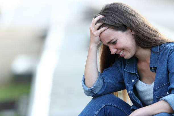 istock Sad girl crying alone in the street 1159620192