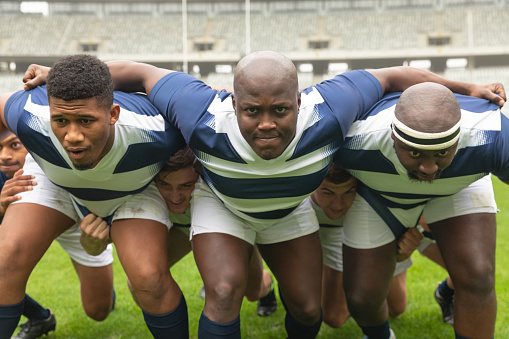 Front view of group of diverse male rugby player ready to play rugby match in stadium