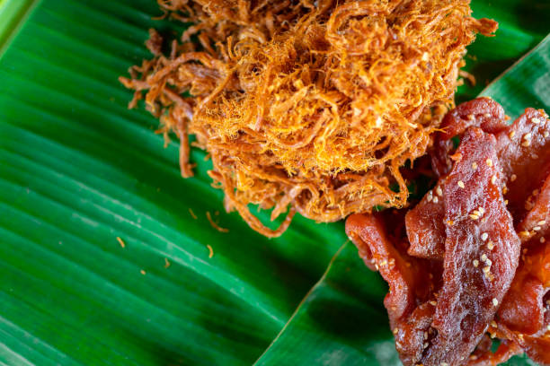 istock Thai food, Fried dried shredded pork on banana leaf. 1159621732