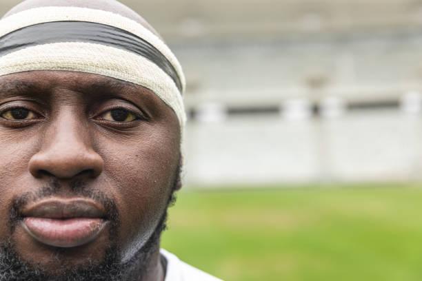 istock African American rugby player looking at camera in the stadium 1159621869
