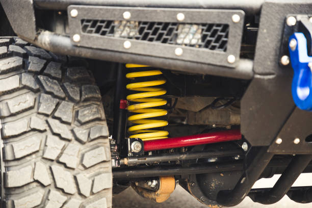 Big off road car coil spring. Yellow shock absorber on the car. Big off road car coil spring. Yellow shock absorber on the car bounce off stock pictures, royalty-free photos & images