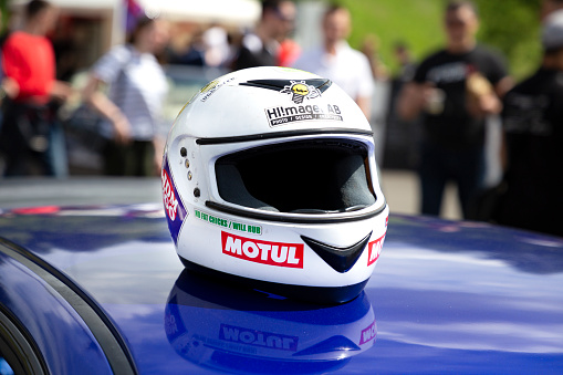 Racing helmet on the car roof. Rider protective gear. Tuning Show, Tomsk, Russia 2019-06-15.