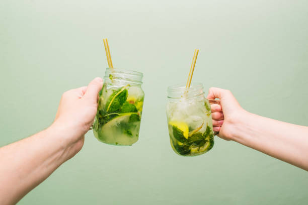 Mojito cocktail in a glass beaker. People keep in their crawfish a summer cold drink with lime, mint and ice. The concept of relaxation and good mood