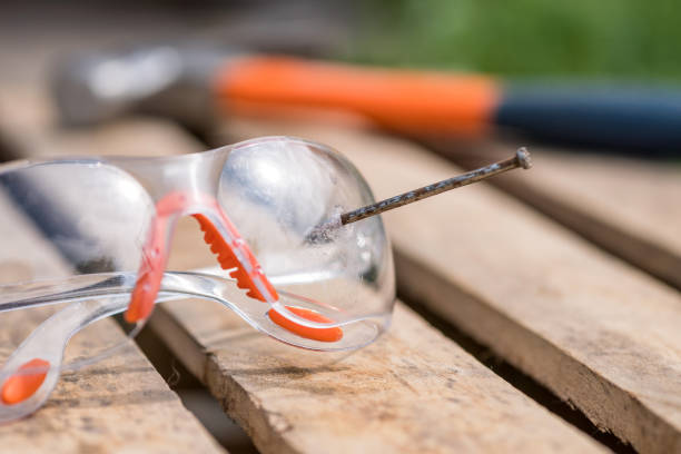 istock broken safety glasses, nail and hammer. protective equipment worker. 1159624104