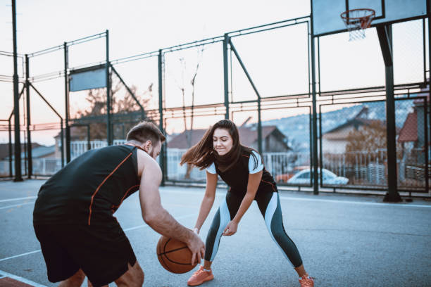 istock Couple Playing Basketball Together During Sunset 1159625541