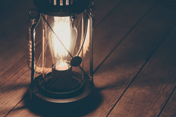 istock retro lamp on wooden floor. creepy light from lantern. 1159625877