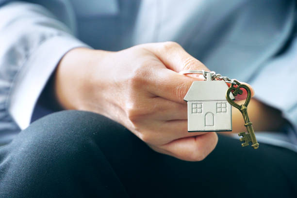 istock Closeup housing key chain on woman's hand. 1159627861