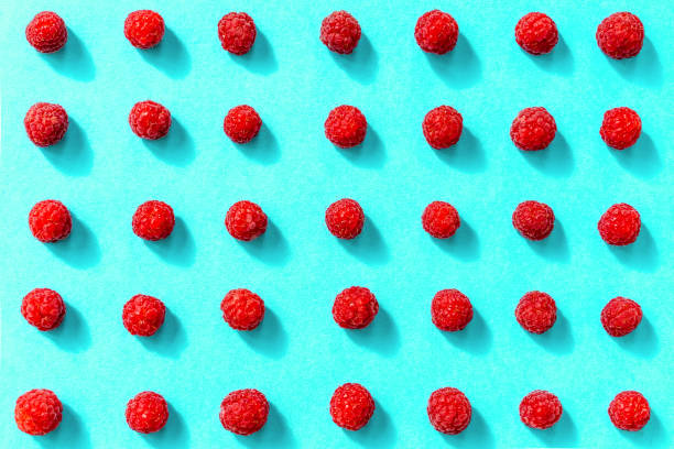 istock Colorful pattern of raspberries on blue background. Flat lay. Top view, pattern 1159628802